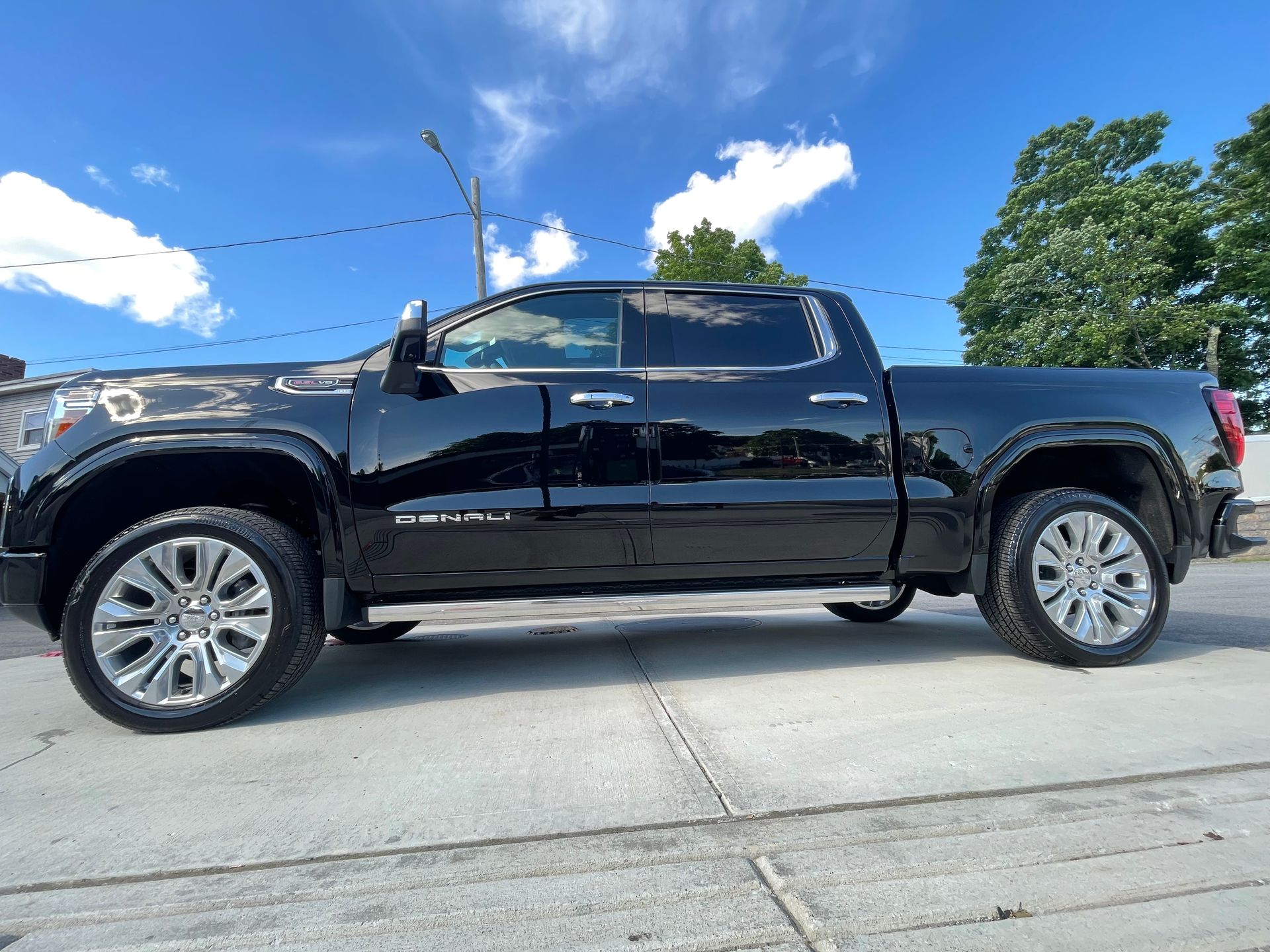 A black pickup truck is parked on the side of the road.