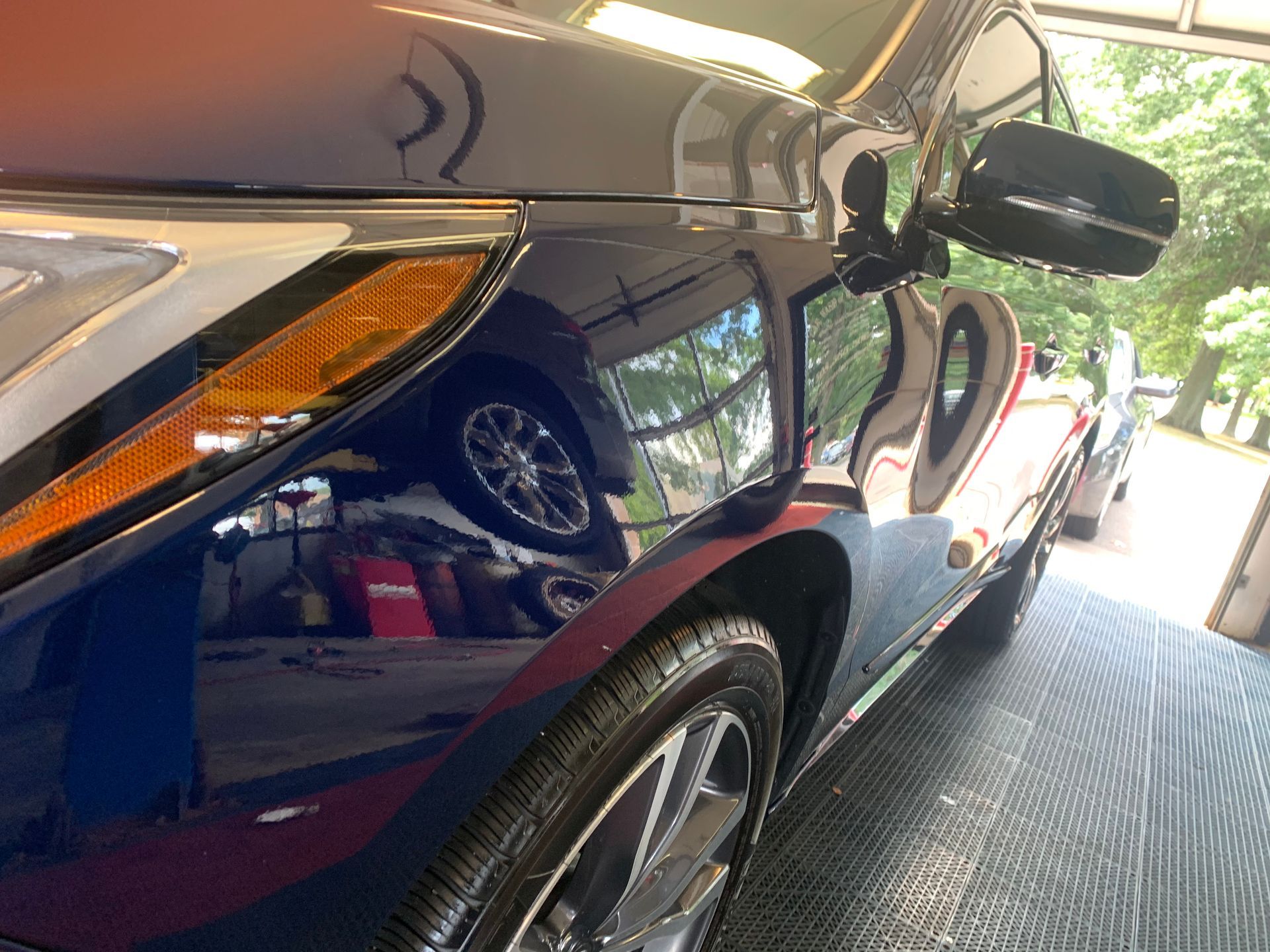 A blue car is parked in a garage.