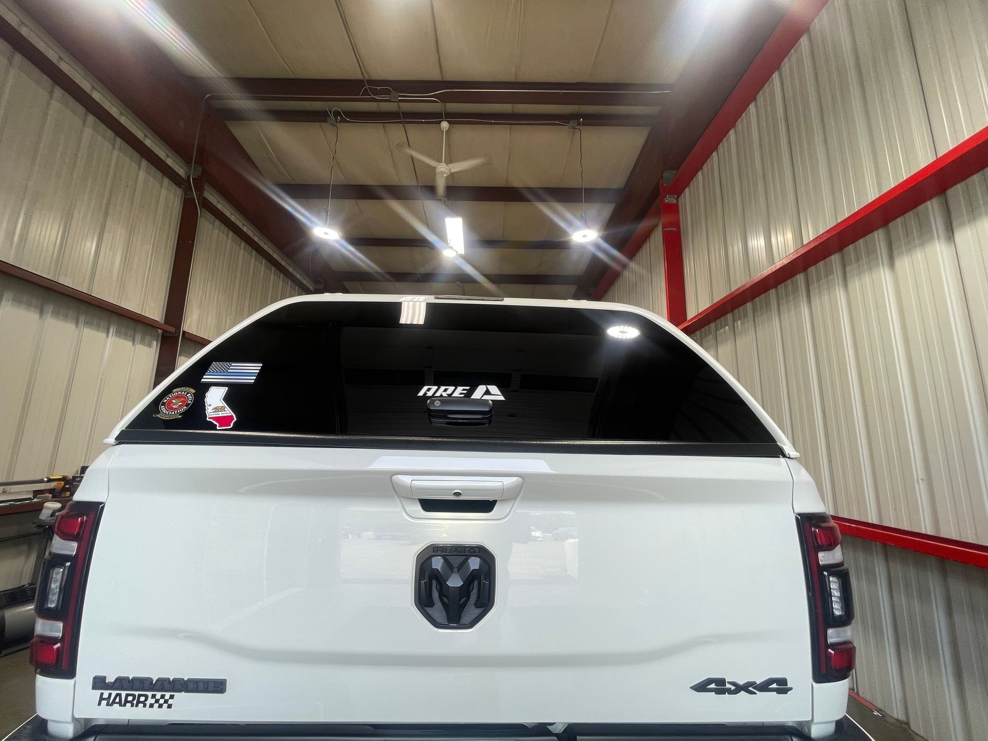 A white dodge ram truck is parked in a garage.