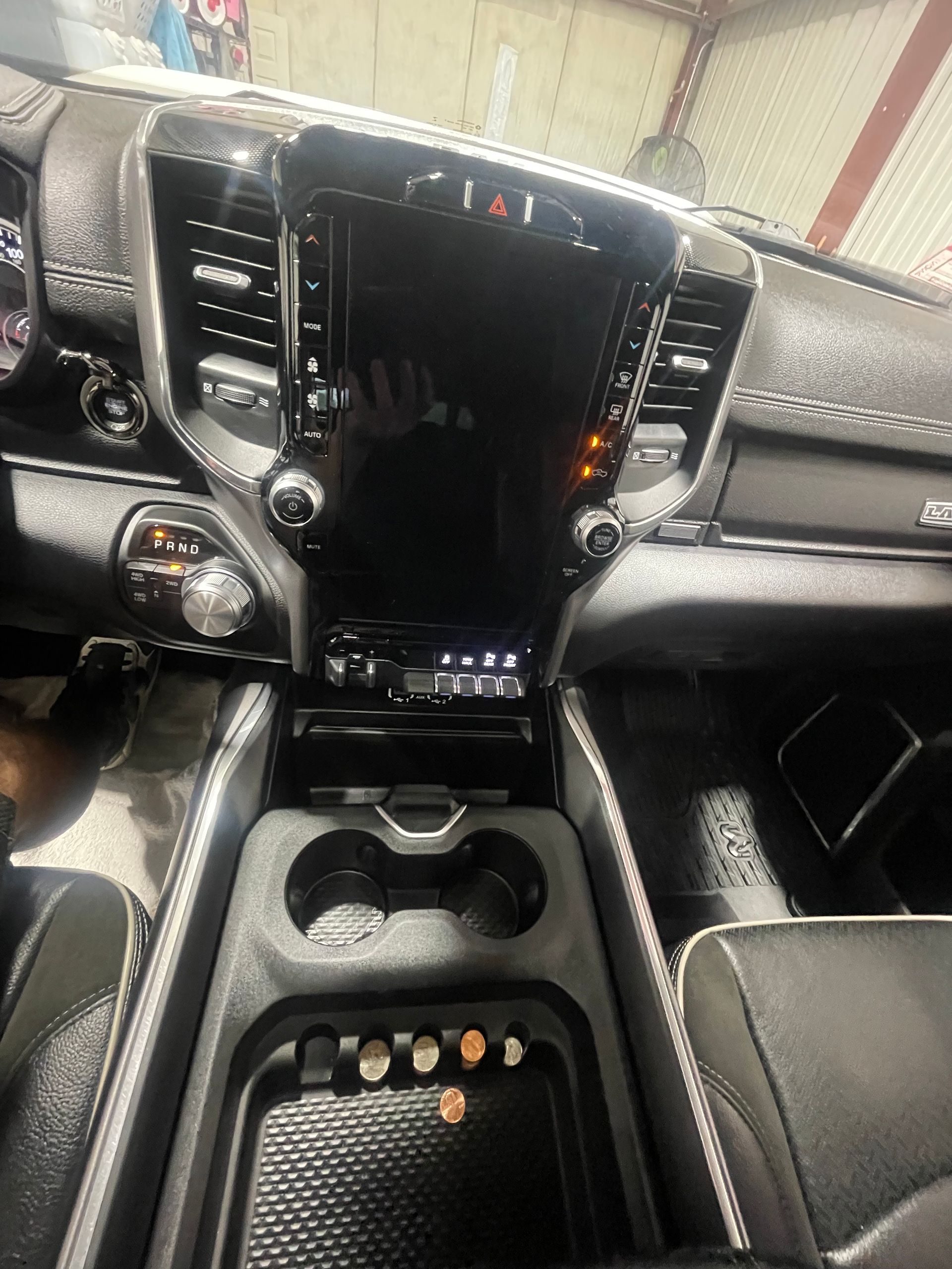 The interior of a dodge ram truck with a touchscreen display.