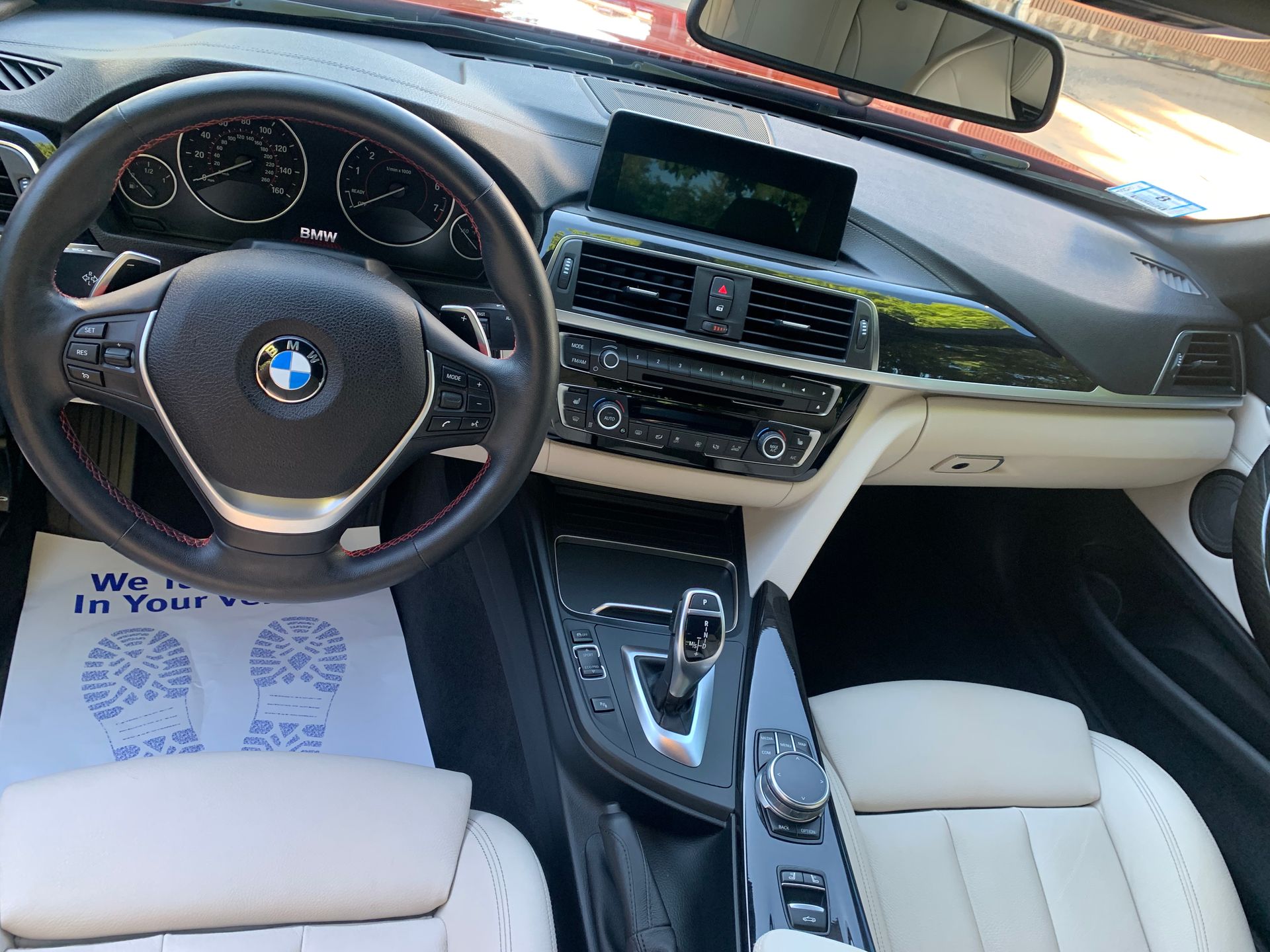 The interior of a bmw with a steering wheel and dashboard