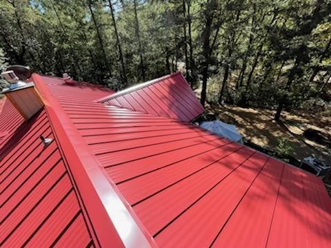 A red roof with trees in the background