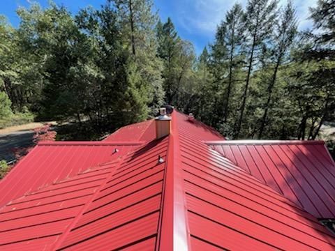 A red roof with a chimney on top of it