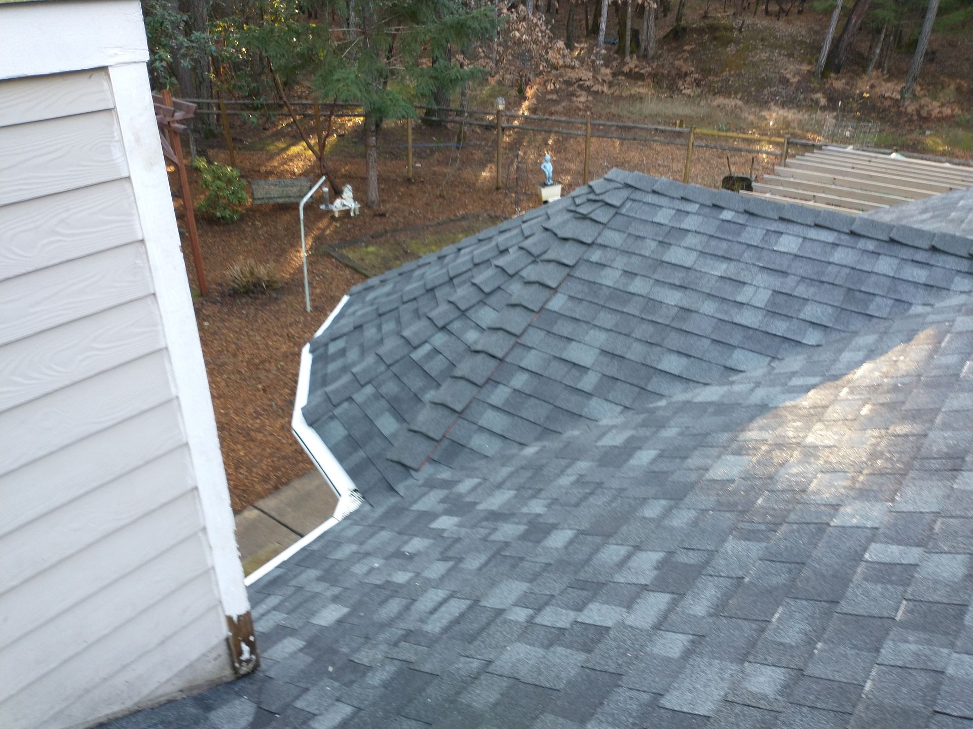 A roof with a gutter on the side of a house.