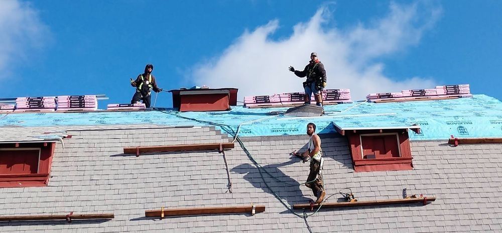 Two men are working on the roof of a building
