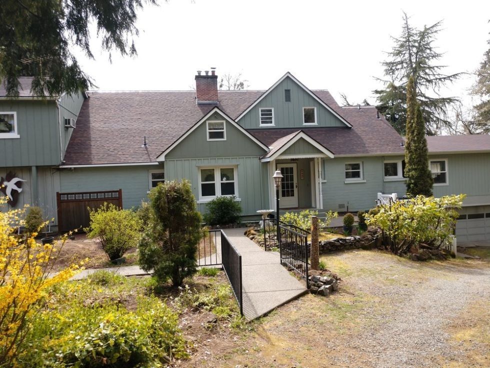 A large house with a walkway leading to the front door