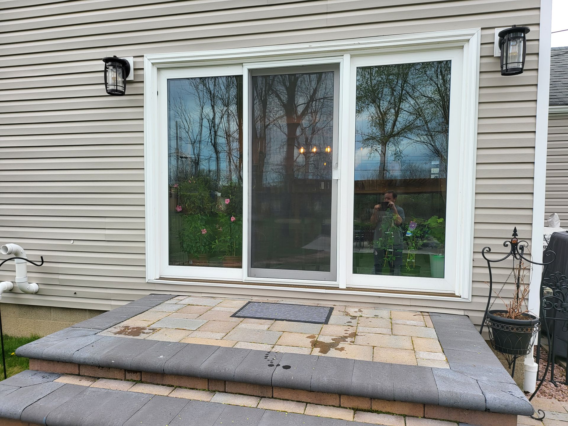 A house with a sliding glass door and steps leading to it.