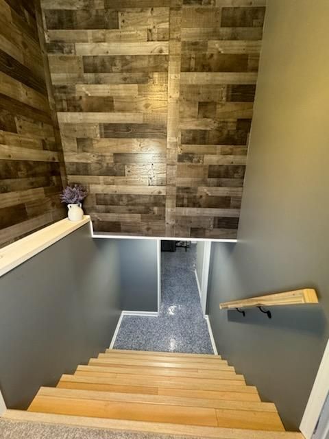 A wooden staircase leading to the basement of a house.
