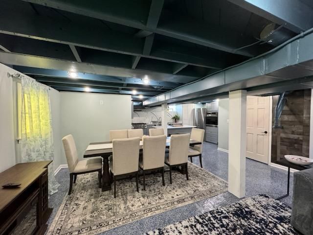 A dining room with a table and chairs in a basement.