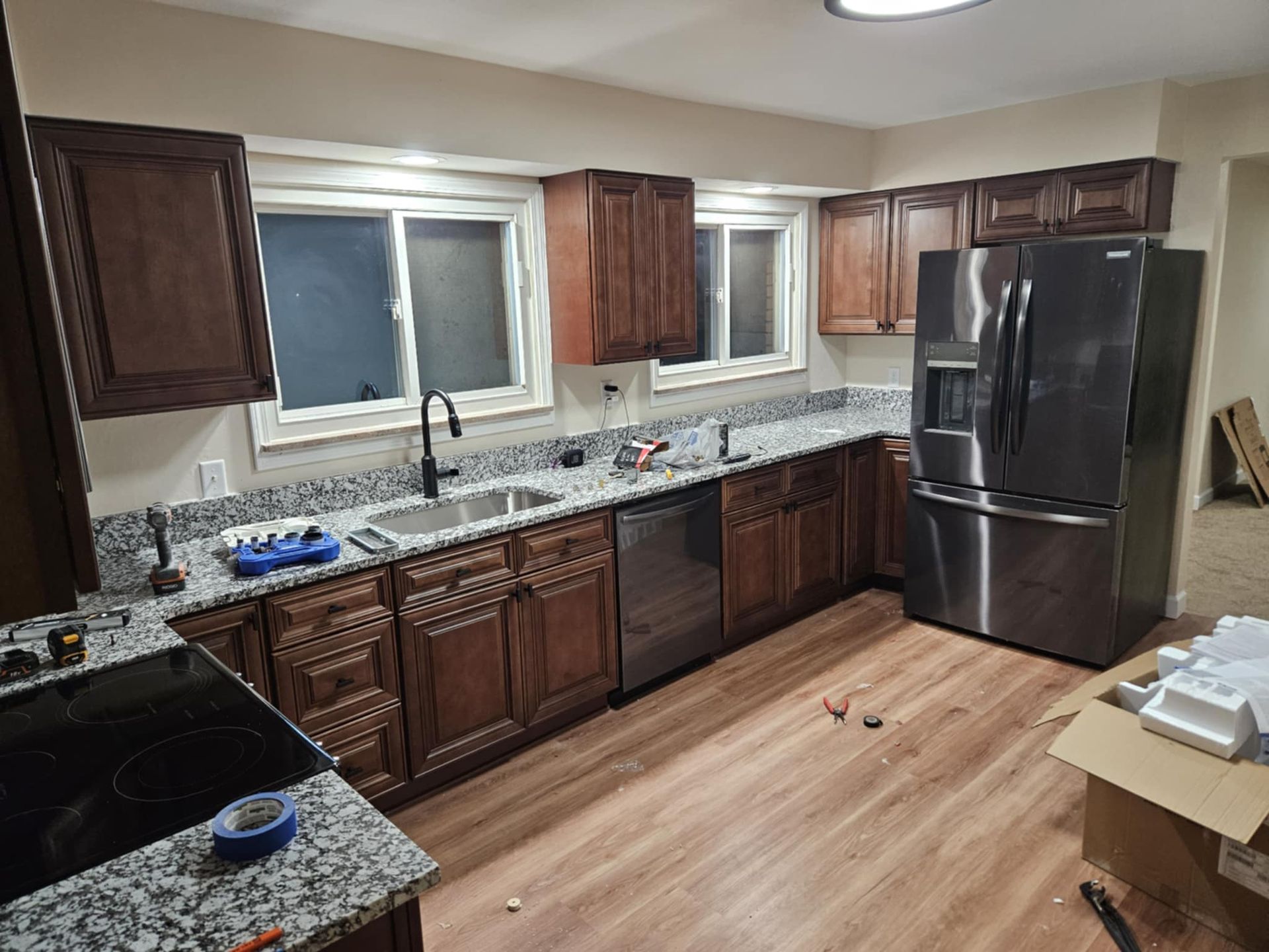 A kitchen with stainless steel appliances and wooden cabinets.