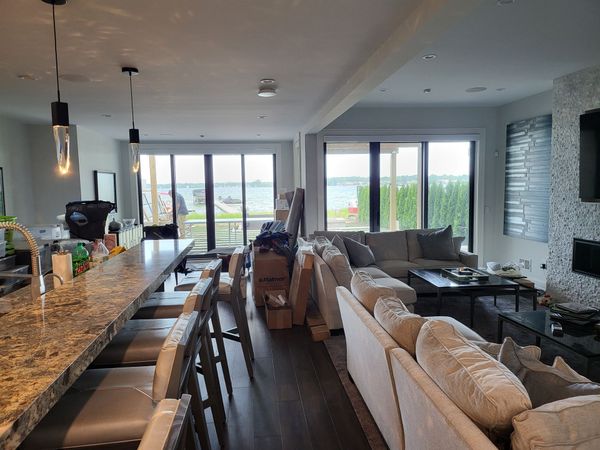 A living room with a lot of furniture and a large window.