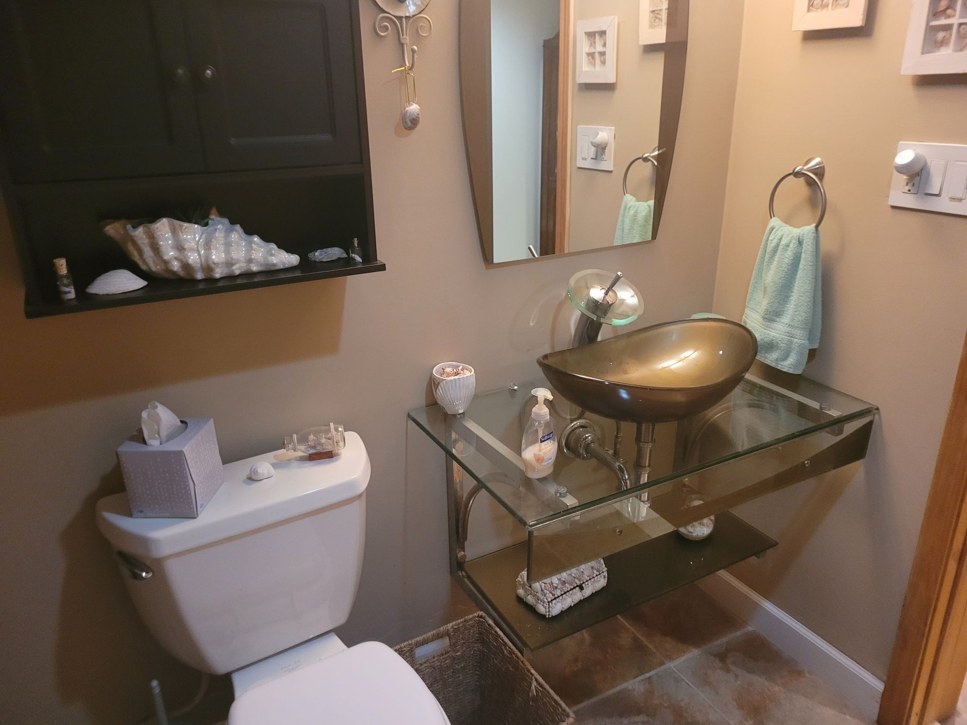 A bathroom with a toilet a sink and a mirror