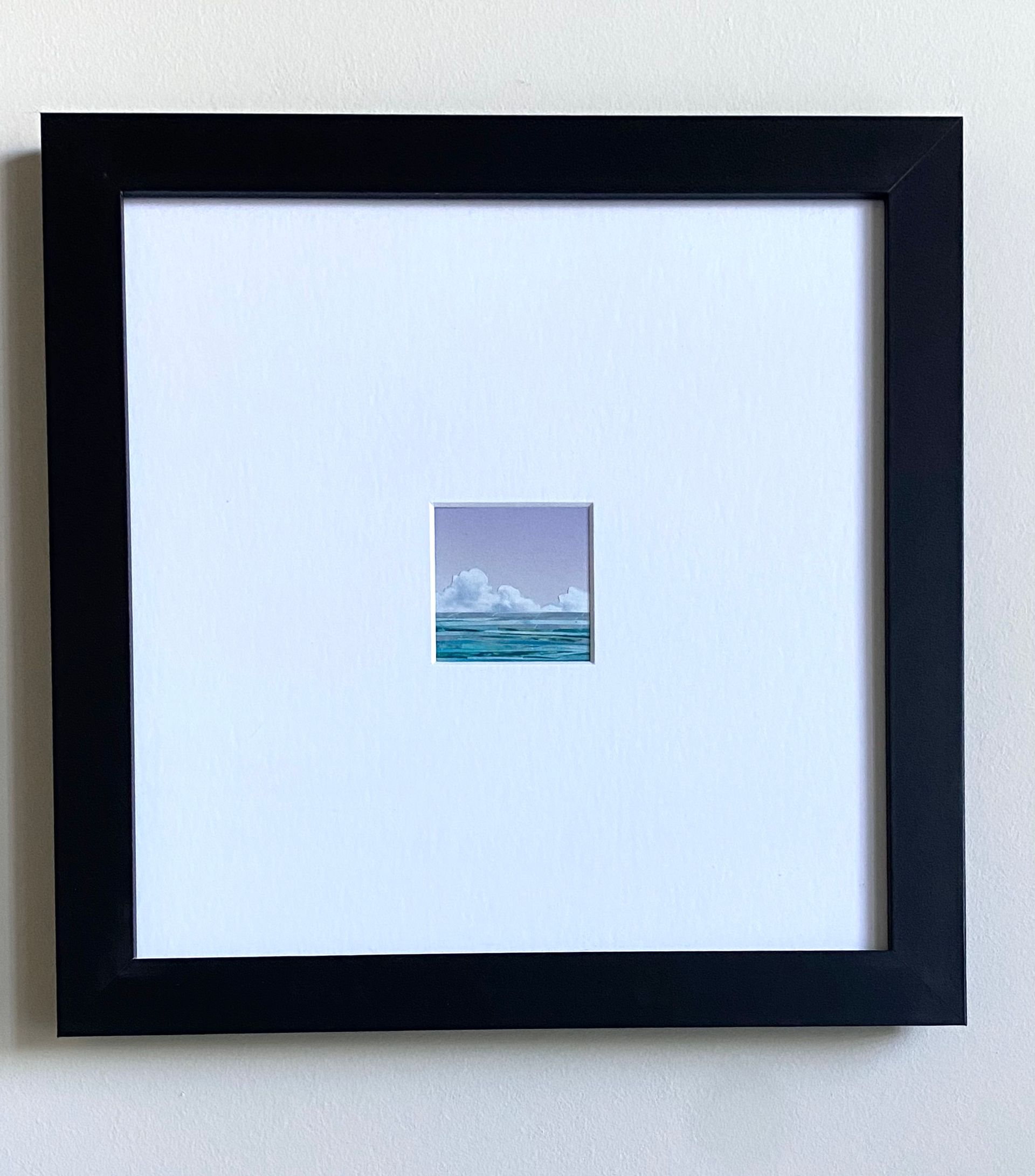 Sky with clouds over a striped turquoise ocean. Lavender sky.