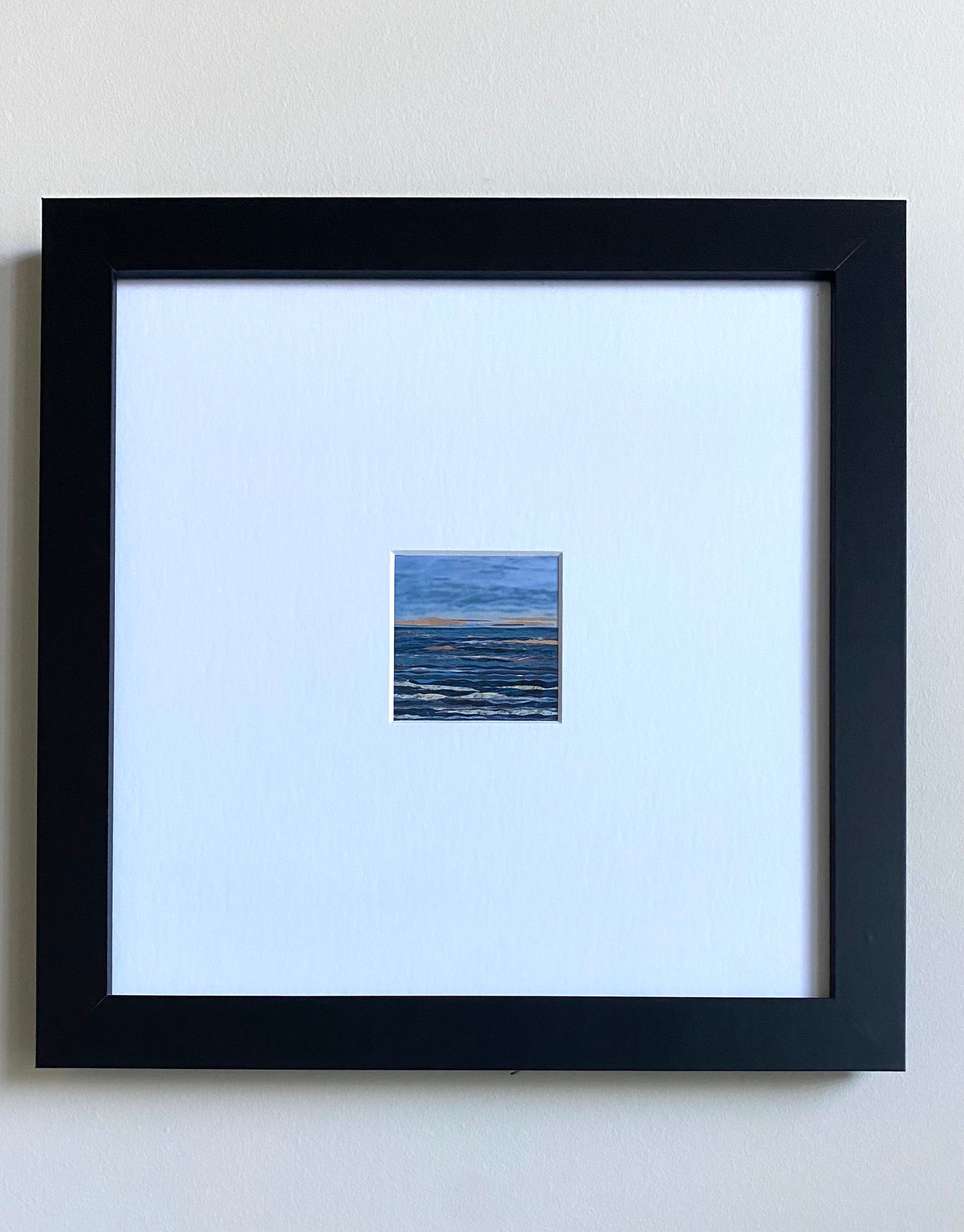 Ocean waves under a cloudy sky, with hints of orange and blue.