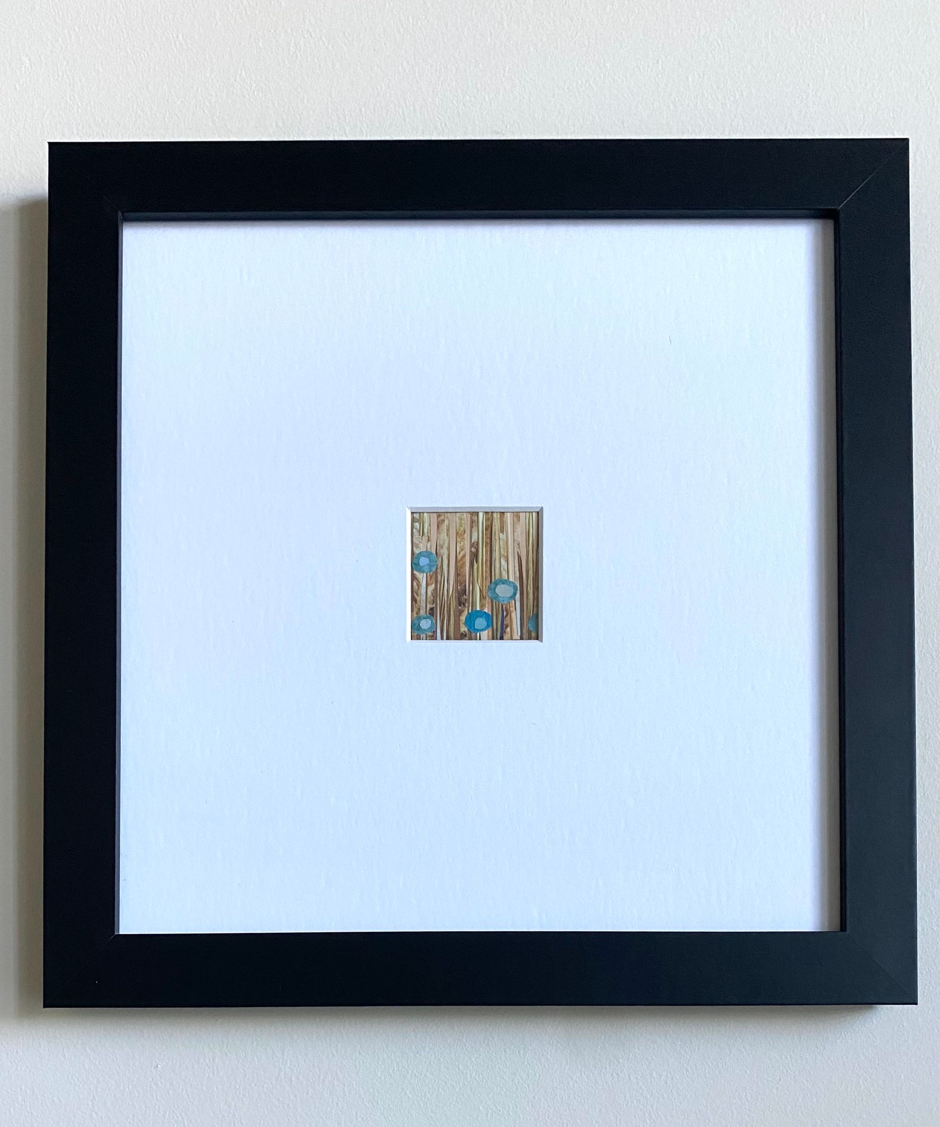 Abstract collage: tall tan stripes with blue and tan circular flower shapes.