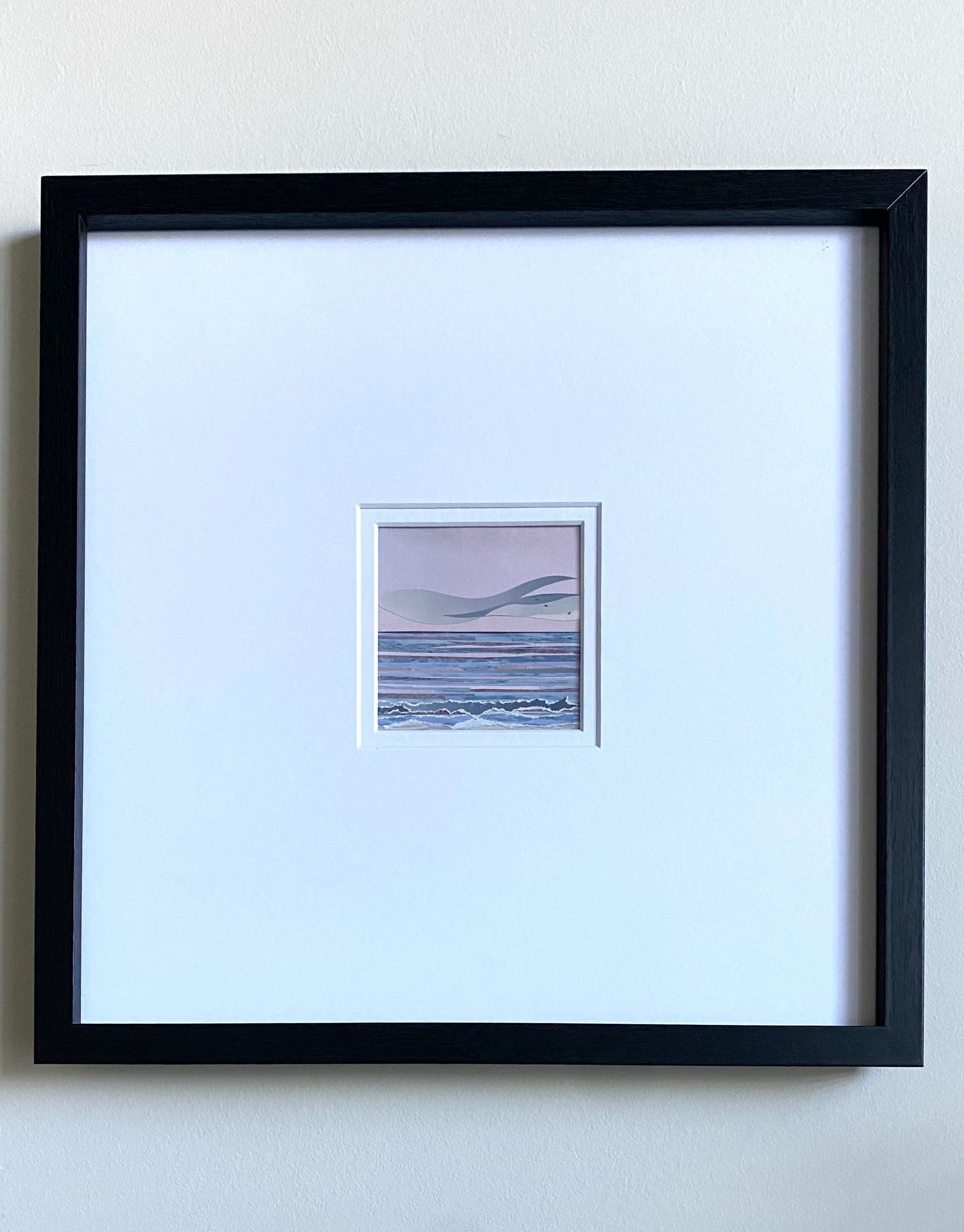 Sea scene with pink sky, blue water, and wavy gray shapes.