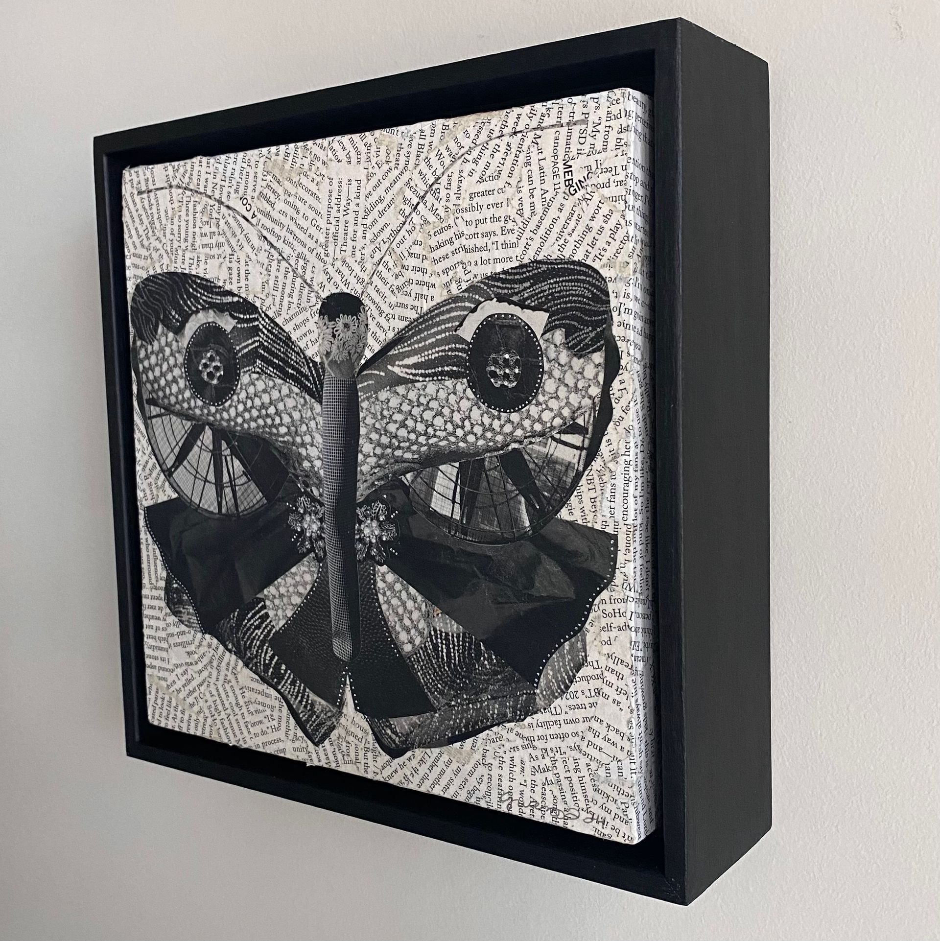 Black and white collage of a butterfly. Wings feature textured patterns with a dot-like background.