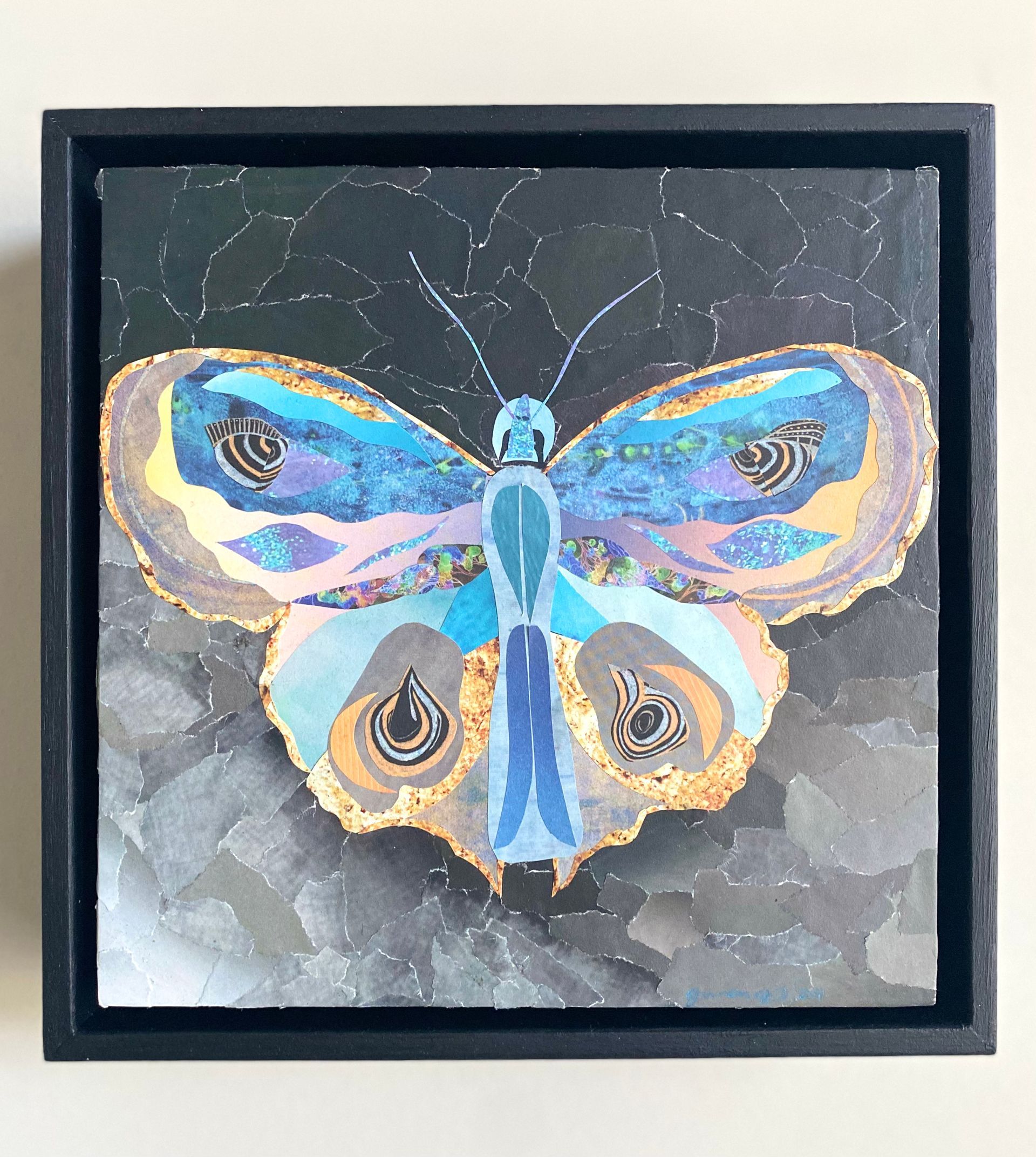 Colorful mosaic butterfly against a textured, dark background.