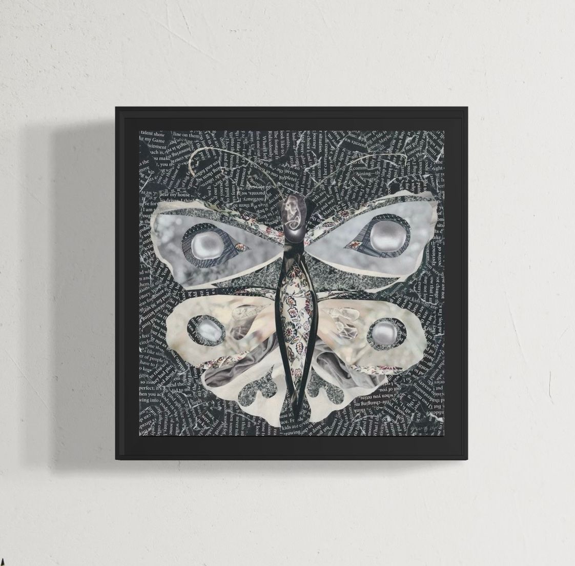 Textile art: white butterfly with floral print, on a dark background.