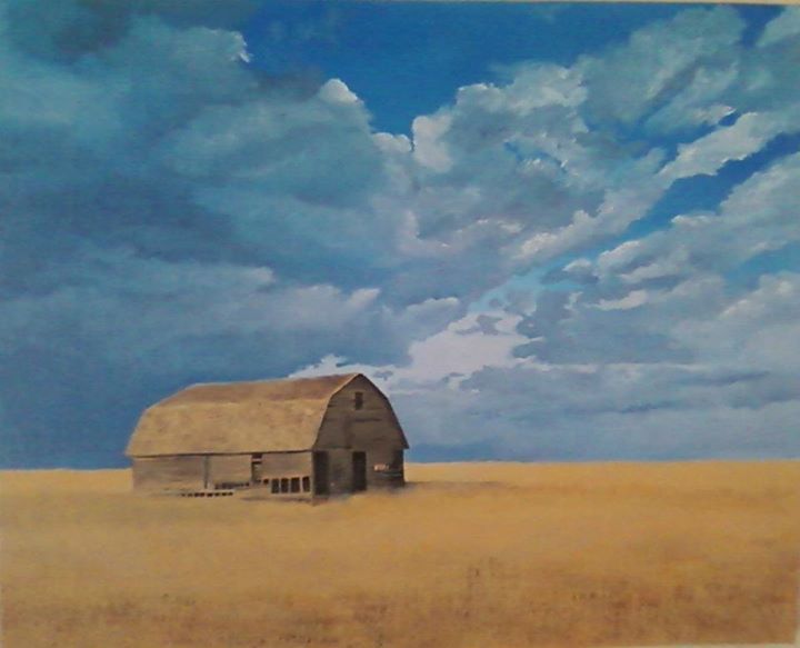 Old wooden barn in a vast, golden field under a dramatic, cloudy blue sky.