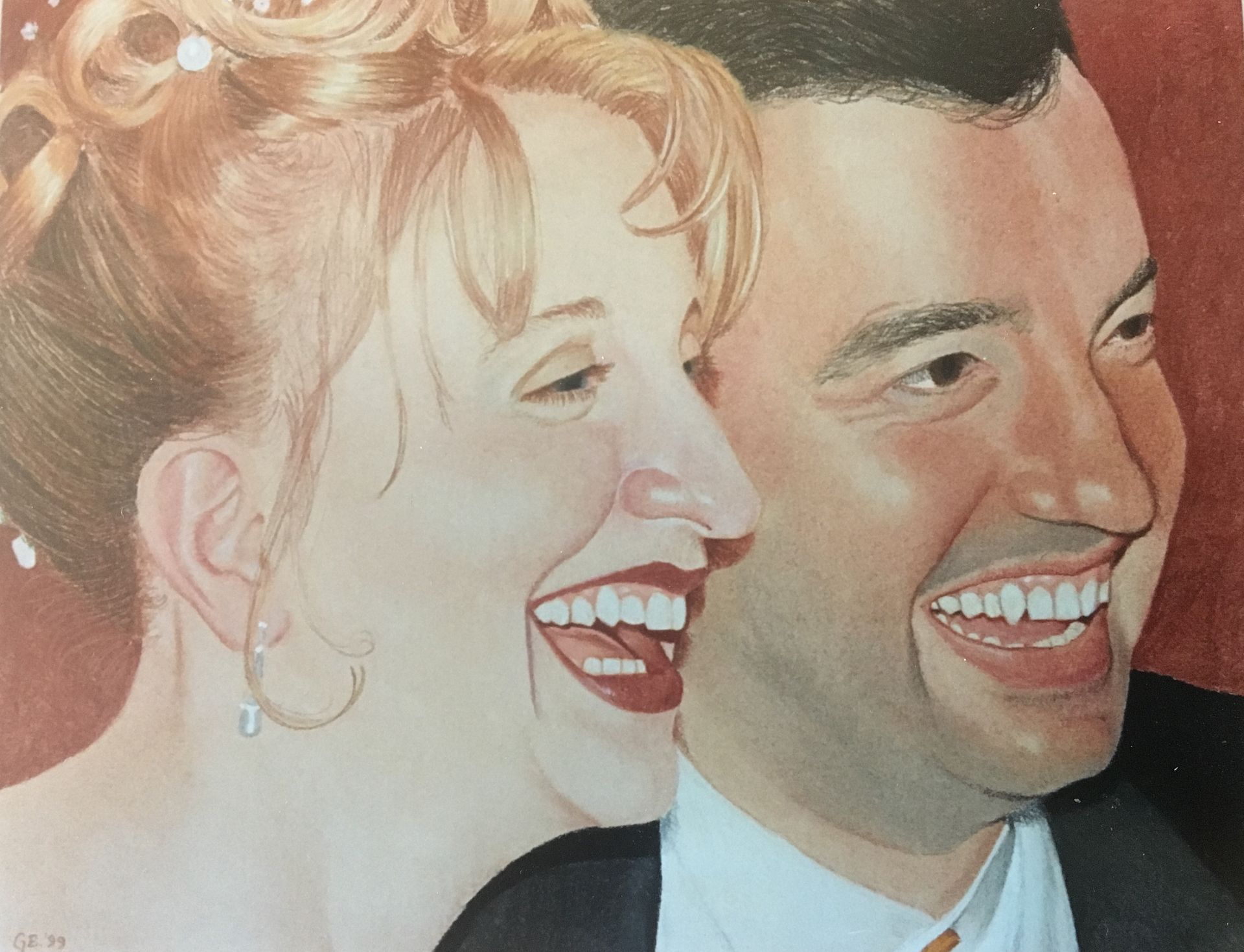 Smiling bride and groom, close-up. Bride with blonde hair and earrings, groom in a suit. Warm, red background.