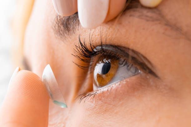 Putting A Contact Lens In Her Eye — Belchertown, MA — Belchertown Eye Care and Sunglass Shop