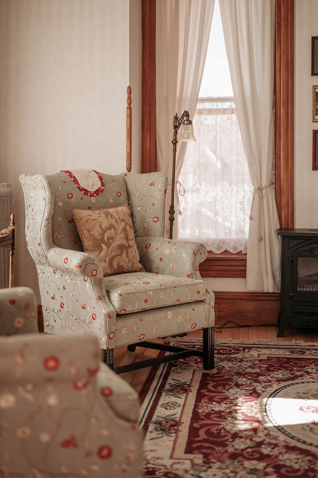 A living room with a chair and a fireplace.