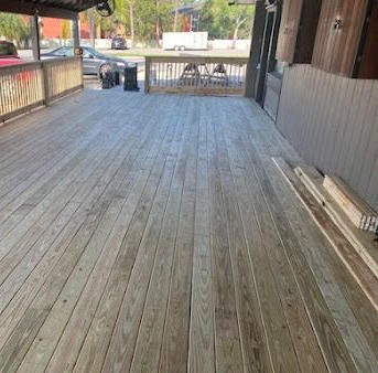Wooden deck with light brown boards, exterior setting.