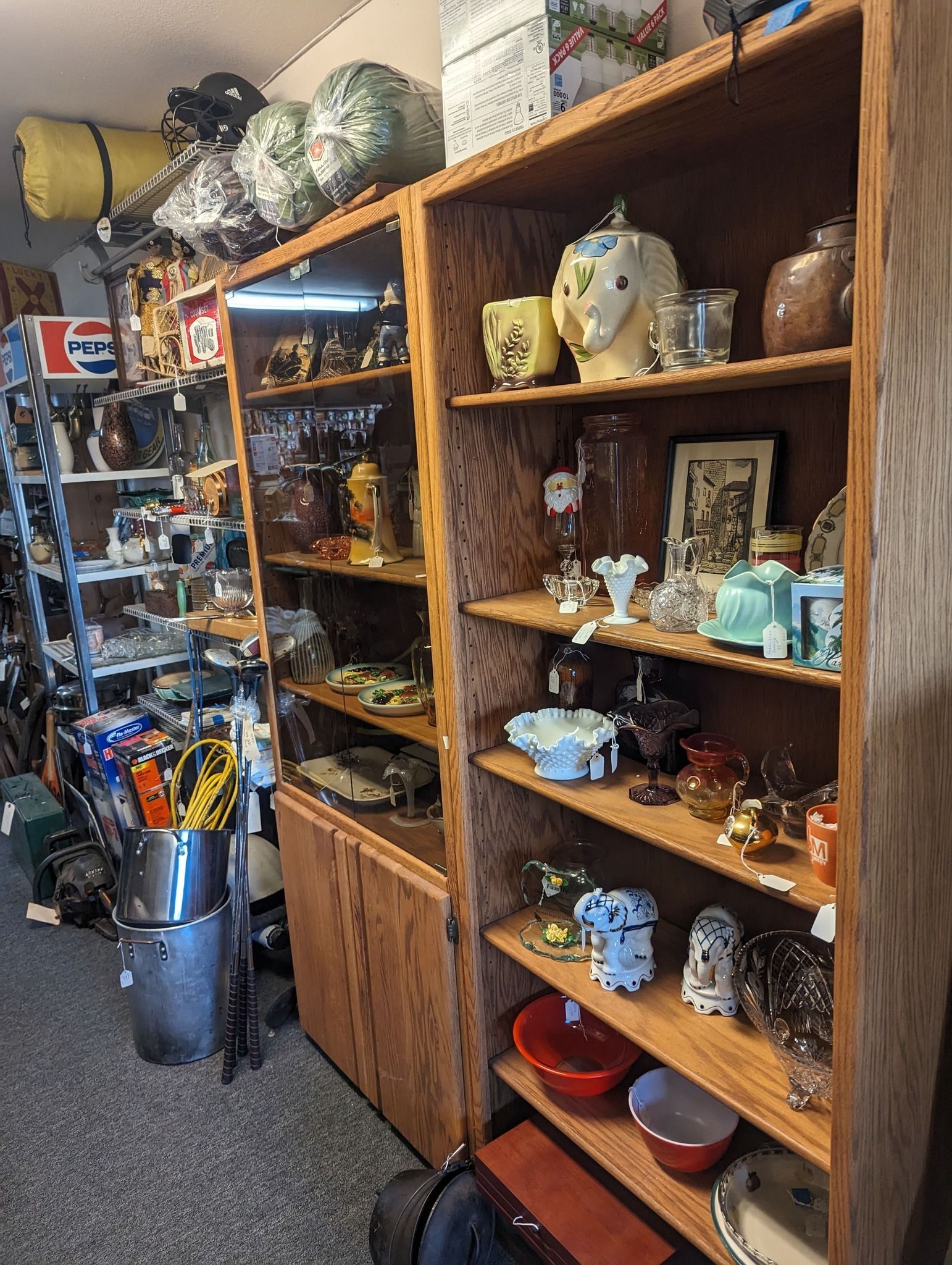 Wooden shelves filled with vintage items in a shop.