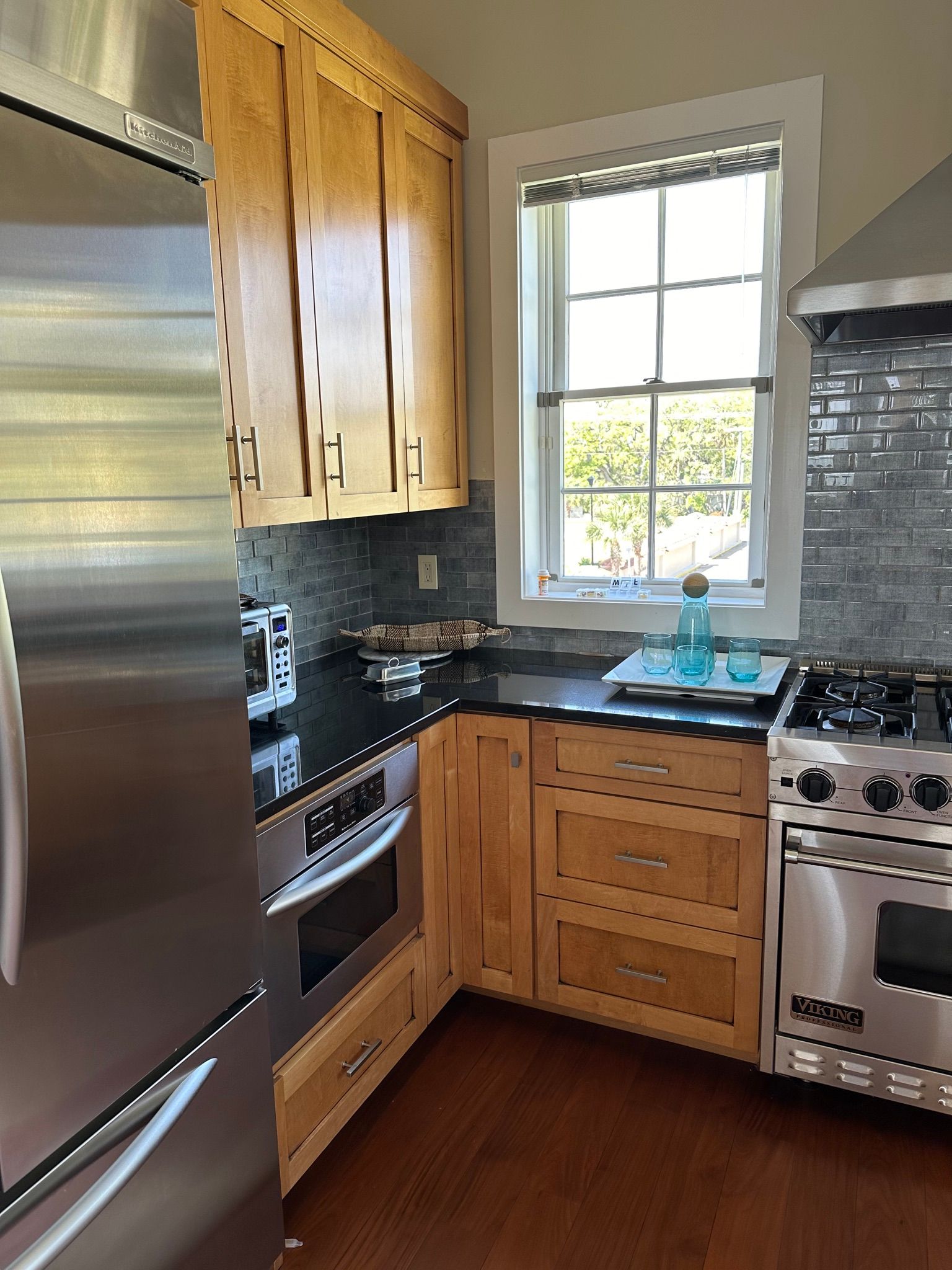 Kitchen with wood cabinets, stainless steel appliances, and dark countertops.