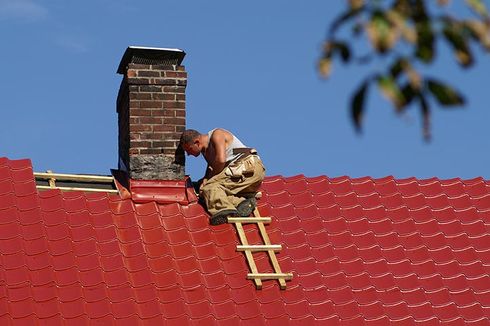 Installing roof around the chimney — Gainesville, FL — Whittle’s Roofing Co. Inc Installing roof around the chimney — Gainesville, FL — Whittle’s Roofing Co. Inc