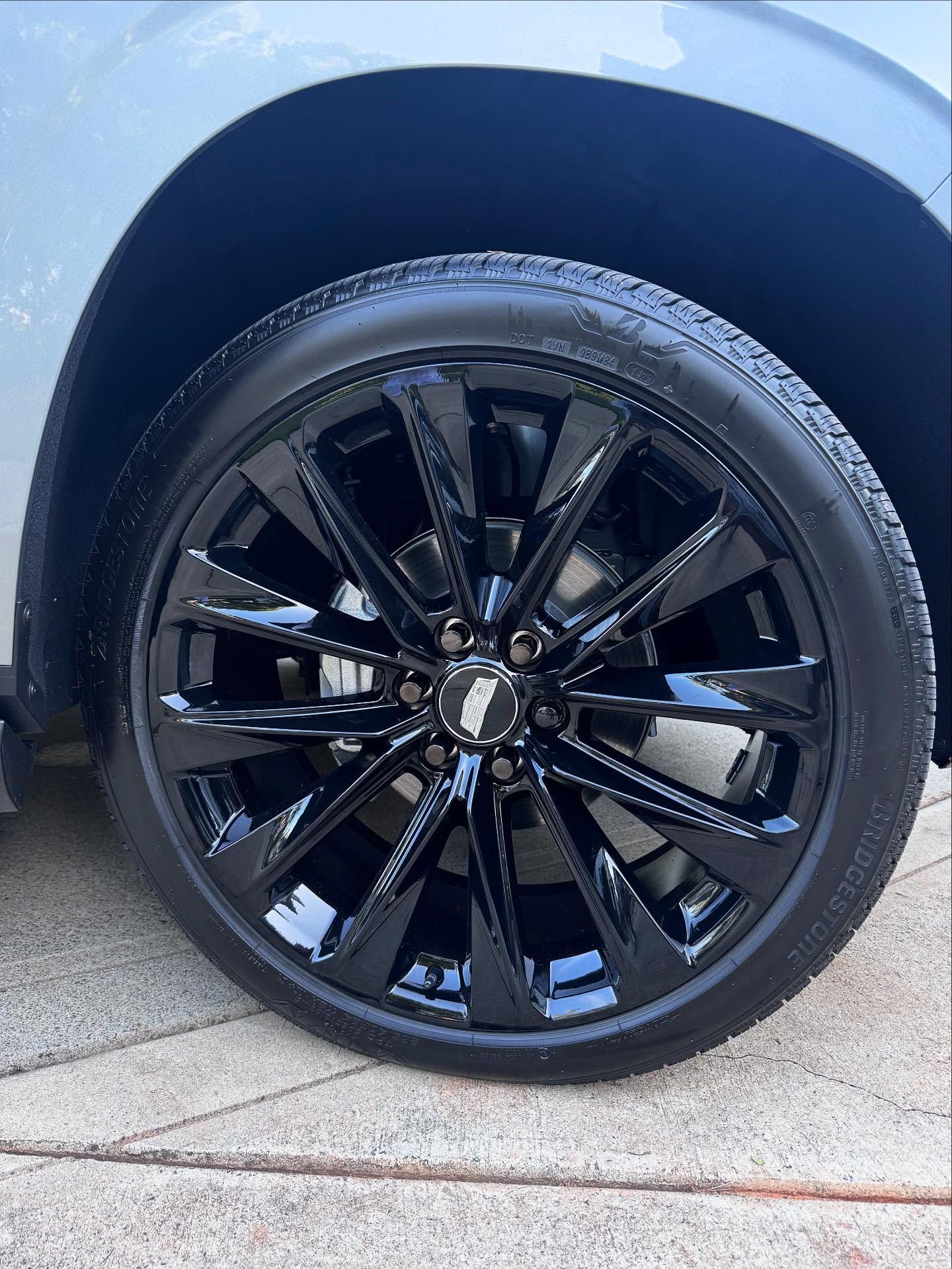 A close up of a black wheel on a car