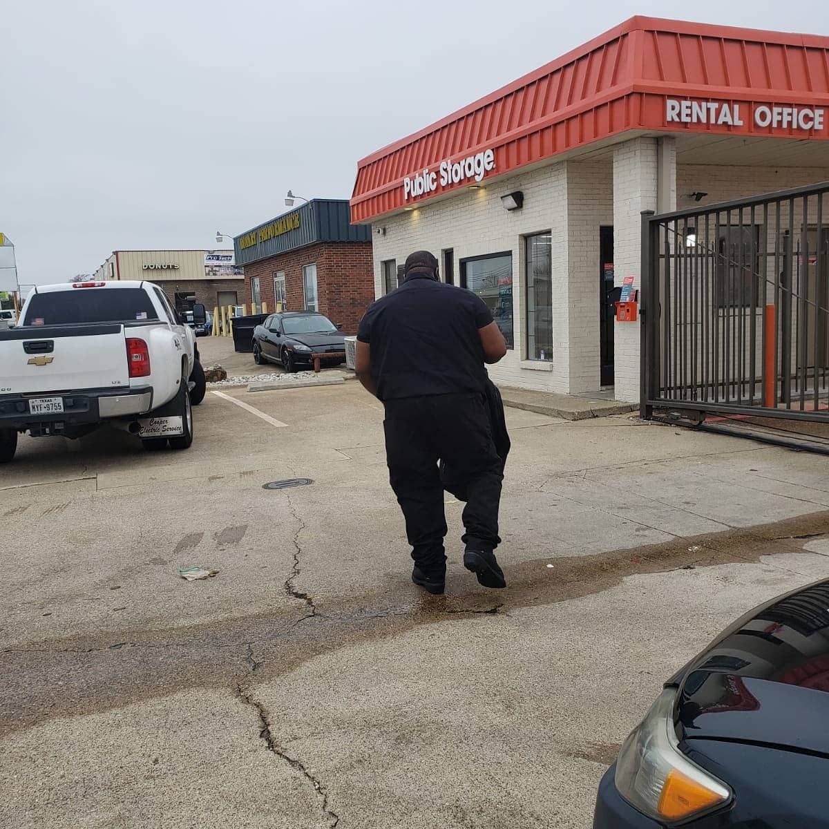 A man walking in front of a rental office