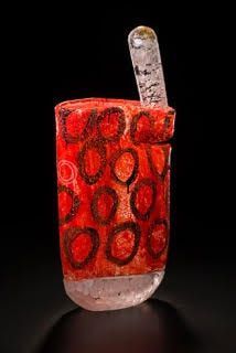 Ancient Egyptian glass cosmetic jar with red decoration and a clear quartz applicator.
