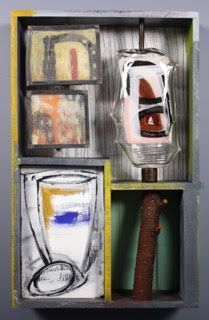 Mixed media art: box with painted sections, glass, a branch, and abstract imagery in various colors.
