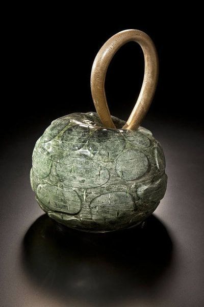 Green stone pendant with a gold loop.