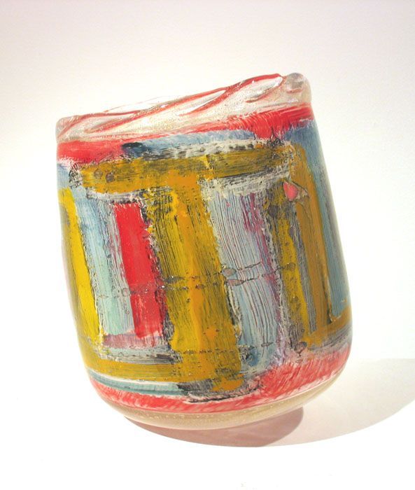 Abstract painted vase in yellow, red, blue, and white, with a textured, irregular surface.