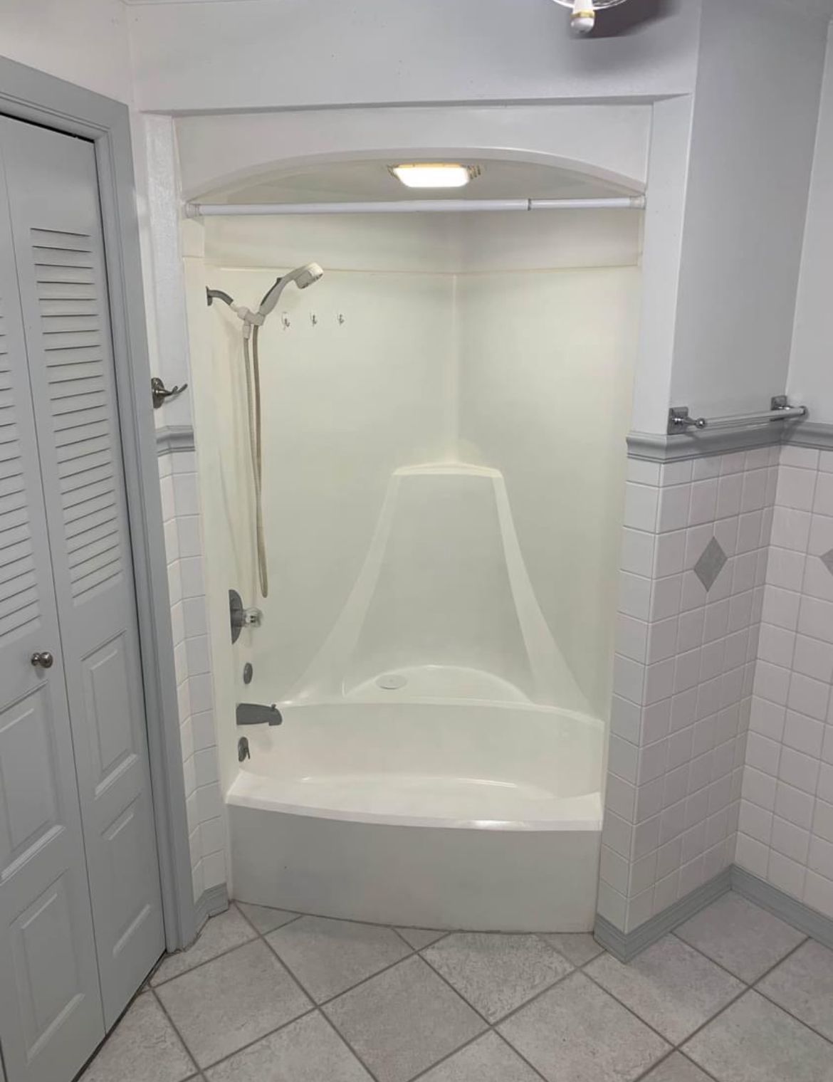 A bathroom with a bathtub and a shower stall.