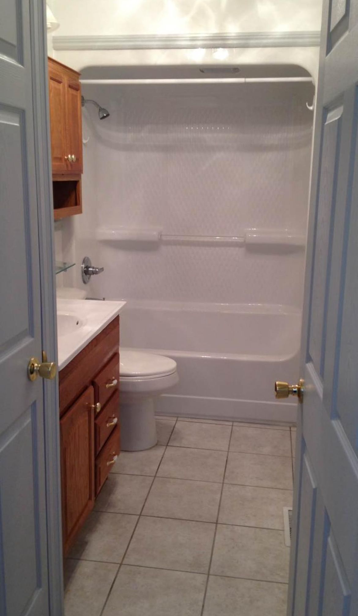 A bathroom with a toilet , sink , bathtub and shower.