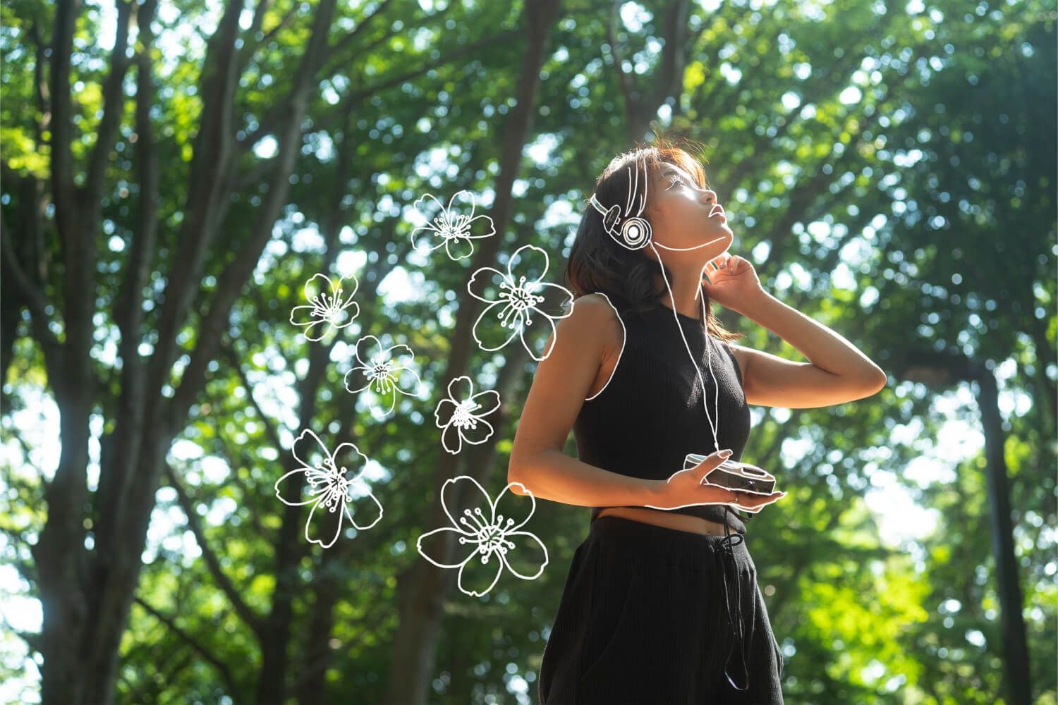 Woman in black dress practicing mindful movement outdoors among trees with decorative flower elements, embodying nervous system regulation