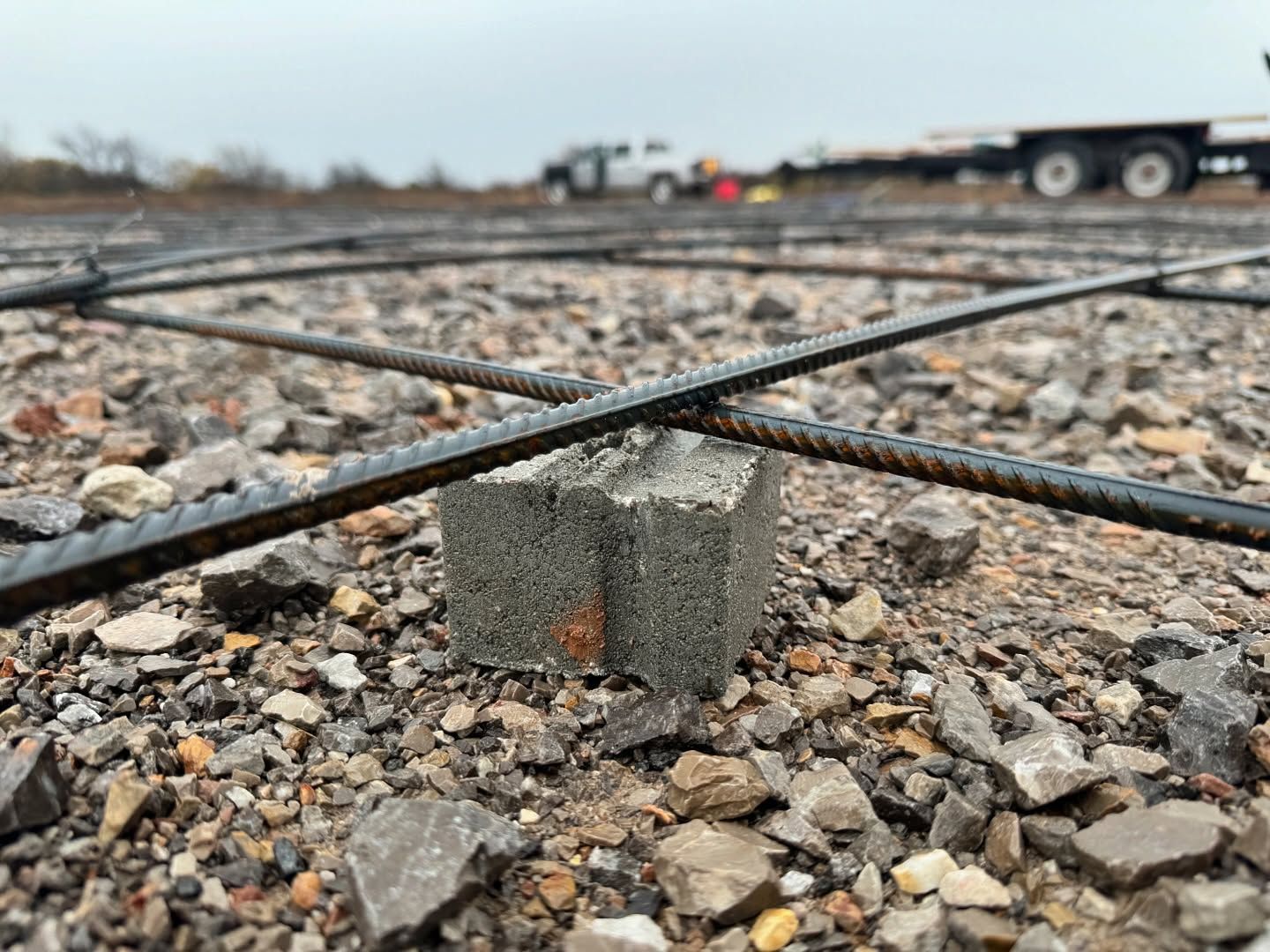 A concrete block is sitting on top of a pile of rocks.