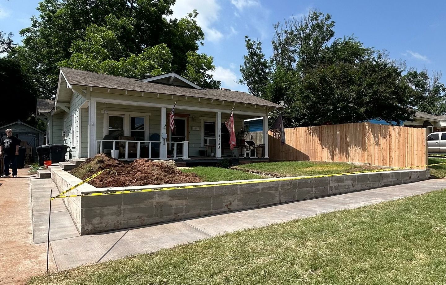 A white house with a wooden fence in front of it.