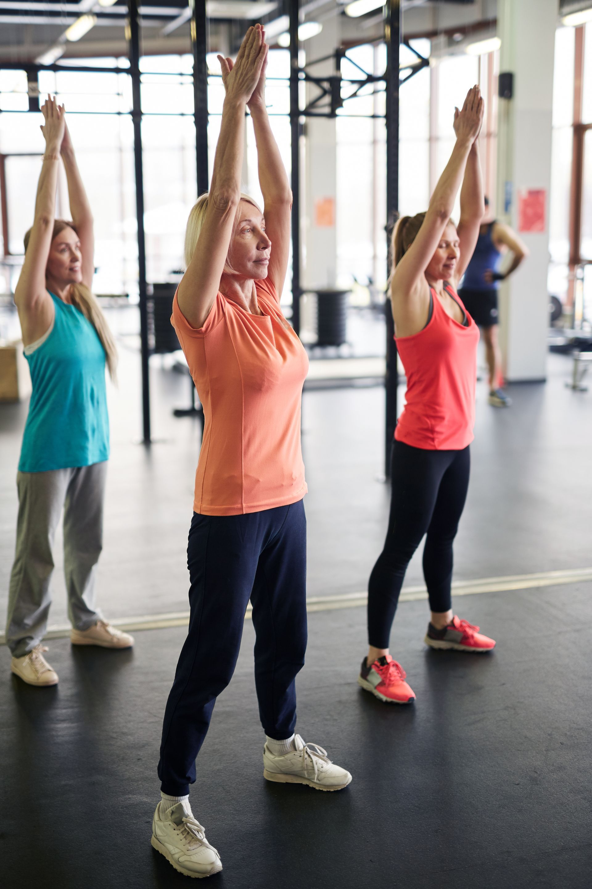 group of women stretching in gym