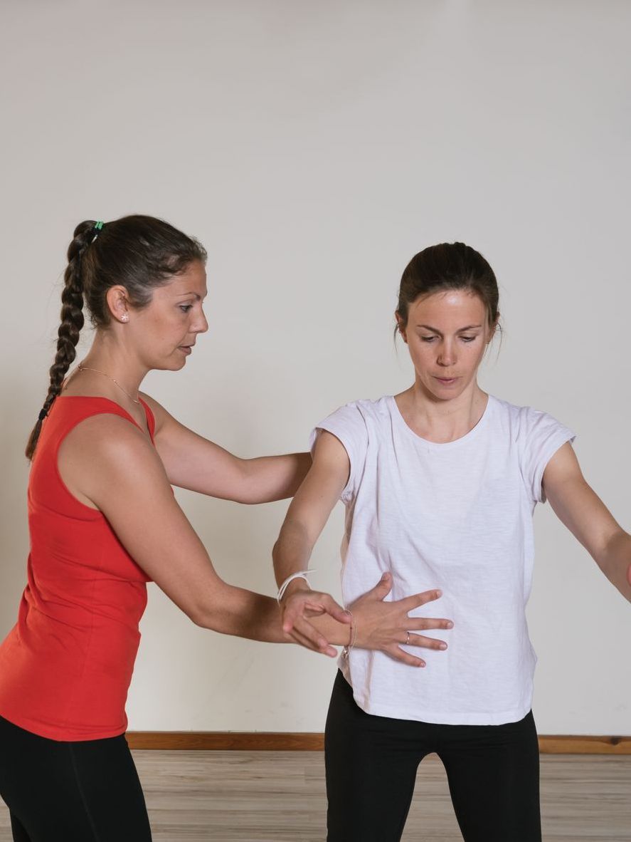 trainer helping with pelvic exercise