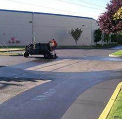 Sealcoating In Process - A Man Using A Machine For Sealcoating in Kent, WA