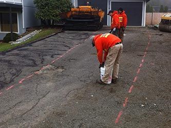 Driveway Before Asphalt - Three Workers Helping Each Other Repairing Driveway in Kent, WA