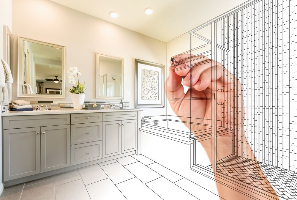 A hand is holding a drawing of a bathroom.
