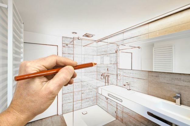 A person is drawing a bathroom with a pencil.