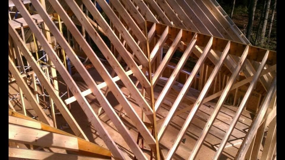 Wooden roof frame under construction.