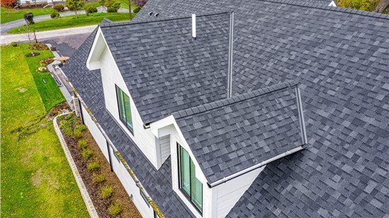 An aerial view of a house with a gray roof.